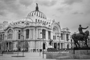 Palace of Fine Arts or Palacio de Bellas Artes, a splendid white marble historic building, a famous concert venue, museum and theatre in Mexico City -Illuminated at night in black and white.