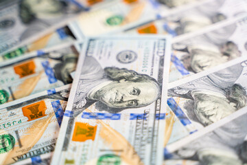 Close-up beautiful clean new one hundred dollar bill lies on other one hundred dollar bills