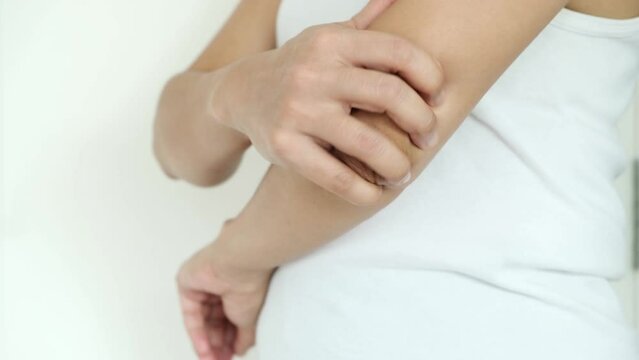 Woman has elbow pain. She squeezes massage, relieves pain from tendon and bone injuries. from sports concept and health care