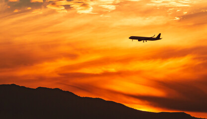 Fototapeta na wymiar Airplans flying in the sunset 