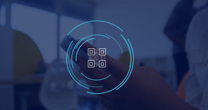 Image of qr code icon over caucasian businesswoman using smartphone in office