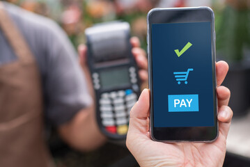 Cropped image of customer paying using smart phone.mobile payment ,online shopping concept
