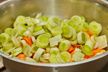 Sliced leeks and carrots in a cooking bowl