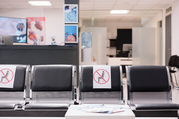 Nobody in empty hospital reception waiting area, medical facility with healthcare service to cure patients with disease. No people in clinic lobby waiting room during covid 19 pandemic.