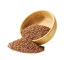 Grains buckwheat are scattered out of the wooden bowl.