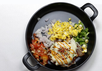 Mini Pizza or homemade baked potato pizza served with onion,tomato,corn,capsicum,cheese and mayonnise.