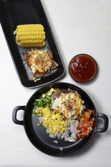 Mini Pizza or homemade baked potato pizza served with onion,tomato,corn,capsicum,cheese and mayonnise.