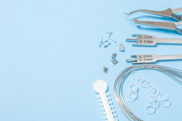 a set of special tools for an orthodontist to install braces for a patient. Orthodontic arcs, ligature, locks, positioner, tweezers