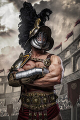 Shot of muscular gladiator dressed in armor and helmet posing with crossed arms in arena.
