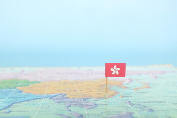 Selective focus of Hong Kong flag in world map. Hong Kong country location and sovereignty concept.