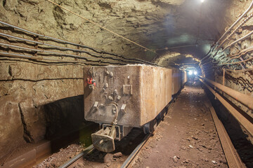 Naklejka premium Old rusty train in iron ore mine.