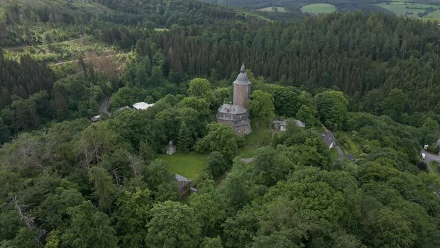 down tilting drone shot of Wildenburg Castle in the southeast of the village of Friesenhagen , in the North Rhine-Westphalia region of Germany