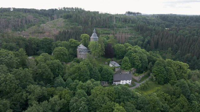 circular drone shot of Wildenburg Castle in the southeast of the village of Friesenhagen, in the North Rhine-Westphalia region of Germany.