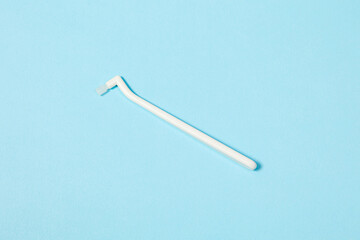 orthodontic toothbrush with one bundle for braces on a blue background special tool for oral care