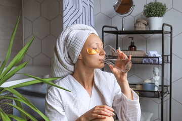 Close up head shot side view happy beautiful young hispanic latina woman with wrapped in towel head...