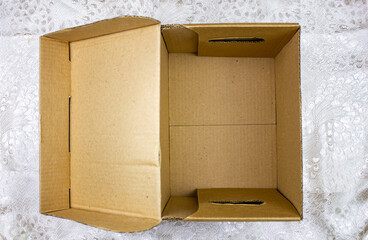 Empty open cardboard box with a bottom. Cardboard packaging for things or objects on a light...