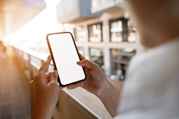Businesswoman using her mobile phone in the balcony