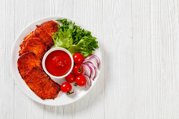 roast slices of pork loin with lettuce and tomato