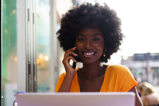 Happy Beautiful Young Black Woman Using Laptop In Cafe