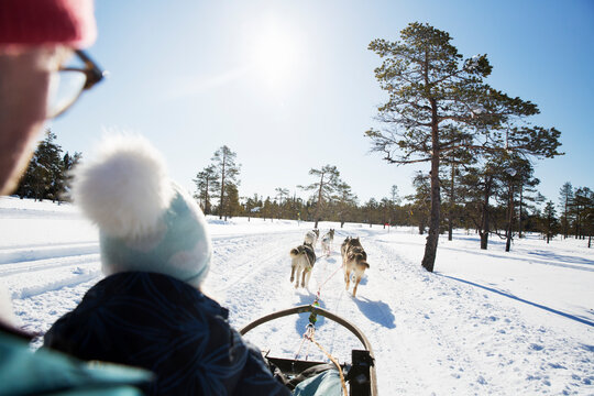 Man with his daughter on dog sled