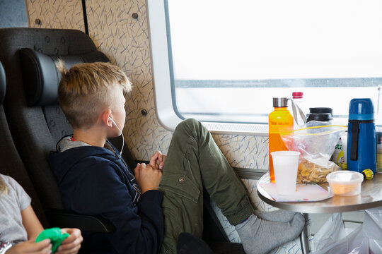 Boy sitting by window of train