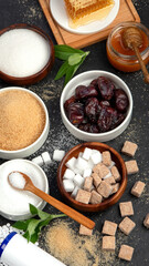 Various diet replacement for sugar on dark background.