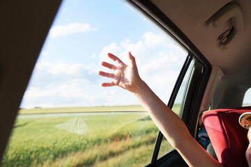 Girl's raised arm in car
