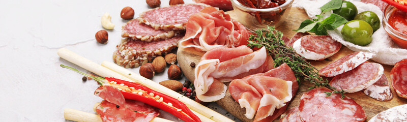 Sausages assortment on light background.