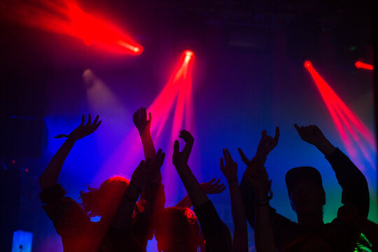 Silhouette of people dancing at concert