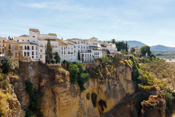 Fototapeta na wymiar Apartment buildings on cliff in Ronda Spain