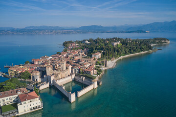 Naklejka na ściany i meble Aerial photography with drone, Rocca Scaligera Castle in Sirmione. Garda, Italy. Popular travel destination on Lake Garda in Italy. Scaligero Castle drone view. Sirmione top view.
