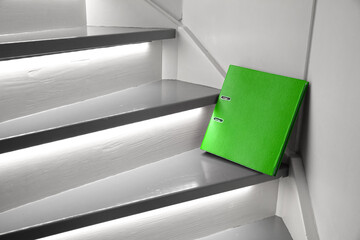 Green file on the stairs, selective focus