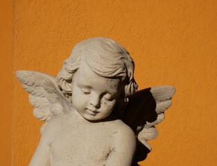 Scale reproduction of the face of an Angel on an orange background
