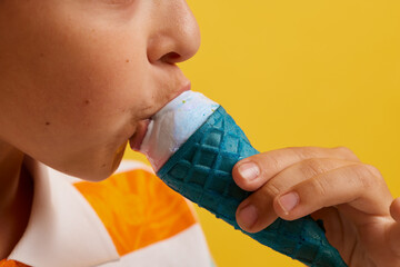 mouth close-up appetizing eating ice cream on a stick on a yellow background