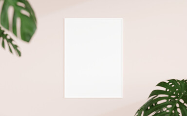 Clean and minimalist front view vertical white photo or poster frame mockup hanging on the wall with blurry plant. 3d rendering.