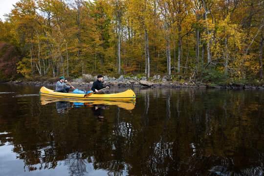 Two men kayaking on river