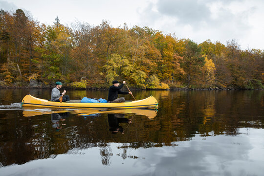 Two men kayaking on river