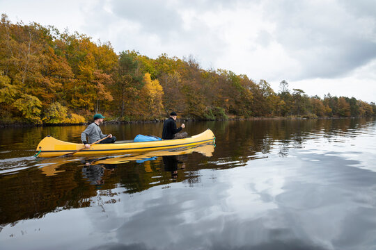 Two men kayaking on river