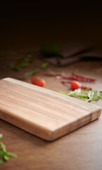 Empty chopping board and spices background