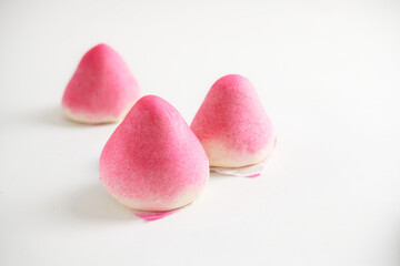 Steam buns on white background. A peach-shaped birthday bun known as the Longevity Peach. Chinese...