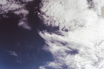 Cloudy sky. Clouds in the dark sky.  Pre-threatening weather. Before the storm. Beautiful natural background. Tinted photo. Natural background with copy space for text and design elements.