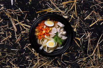 Soup with carrots, zucchini, boiled egg, meat, spaghetti