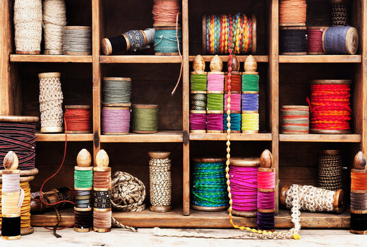 Spools of thread and ribbon on shelves