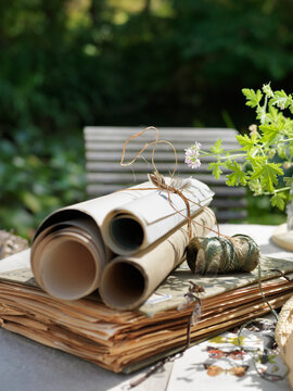 Scrolls and book on table outdoors
