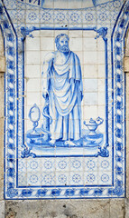 detail of a panel of azulejos blue and white tiles from the facade of an old pharmacy in Leiria, Portugal