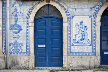 Fototapeta na wymiar detail of a panel of azulejos blue and white tiles from the facade of an old pharmacy in Leiria, Portugal