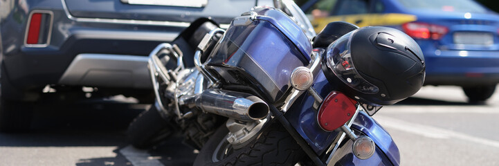 Traffic accident between electric bicycle and car, motorbike fell on asphalt