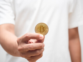 Closeup man hand holding golden bitcoin digital money