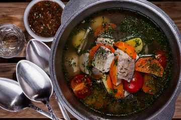 Soup with fish, tomatoes, carrots, potatoes, and peppers