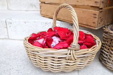 Fototapeta na wymiar Wicker basket full of rose petals